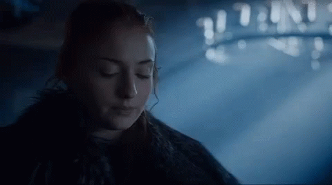 A Close Up Of A Woman With Her Eyes Closed In A Dark Room . GIF