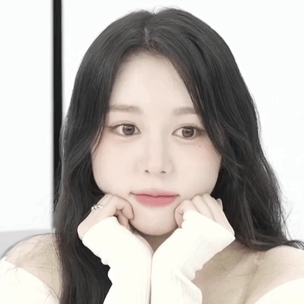 A Close Up Of A Woman With Her Hands On Her Chin GIF