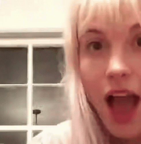 A Close Up Of A Woman With Her Mouth Open . GIF