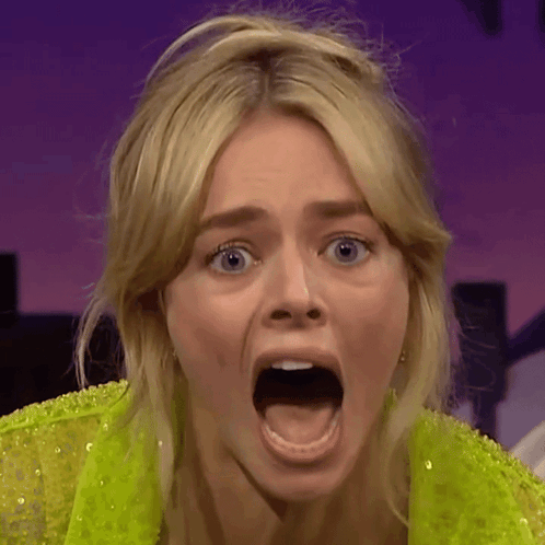 A Close Up Of A Woman With Her Mouth Wide Open GIF