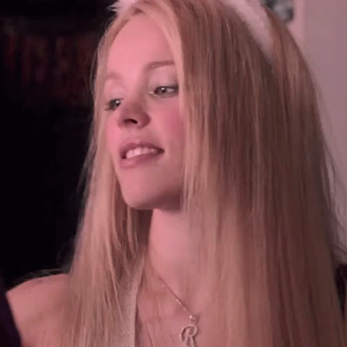 A Close Up Of A Woman With Long Blonde Hair Wearing A Cat Ear Headband And A Necklace . GIF