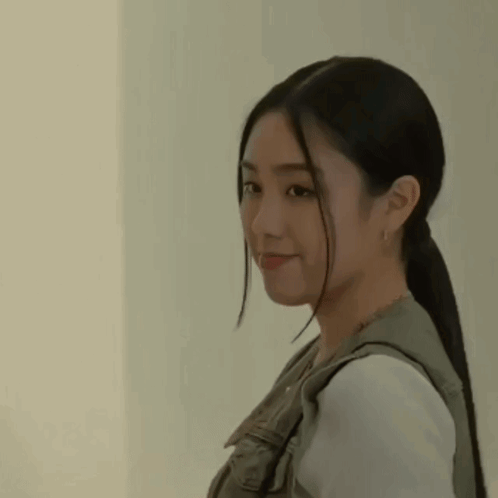 A Close Up Of A Woman With Long Hair In A Ponytail . GIF