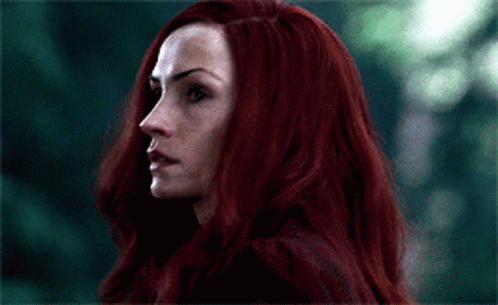 A Close Up Of A Woman With Long Red Hair GIF
