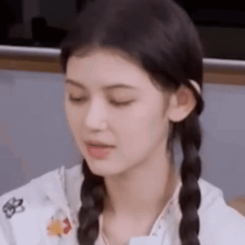 A Close Up Of A Woman With Pigtails Making A Face . GIF