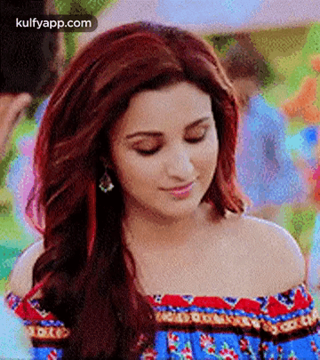 A Close Up Of A Woman With Red Hair Wearing A Blue Off The Shoulder Top . GIF