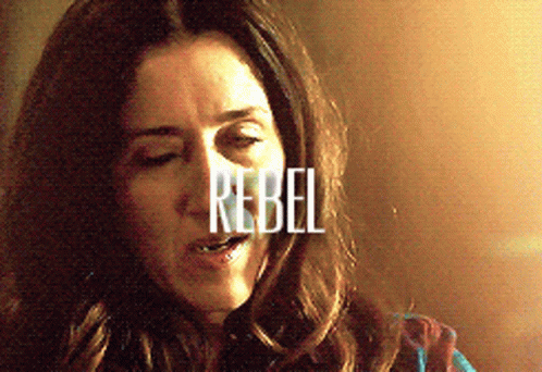 A Close Up Of A Woman With The Word Rebel Written On Her Face GIF