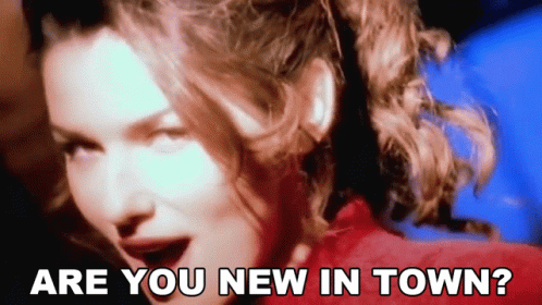 A Close Up Of A Woman With The Words " Are You New In Town " Above Her GIF