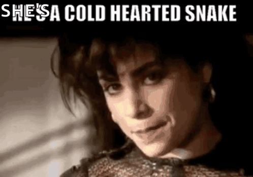 A Close Up Of A Woman With The Words She 'S A Cold Hearted Snake Above Her GIF
