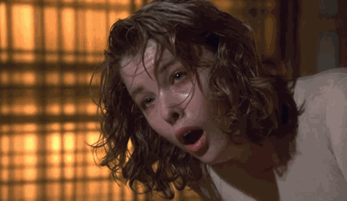 A Close Up Of A Woman With Wet Hair And Her Mouth Open GIF