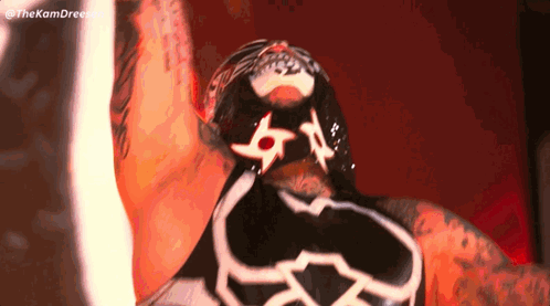 A Close Up Of A Wrestler 'S Face With A Mask On His Face GIF