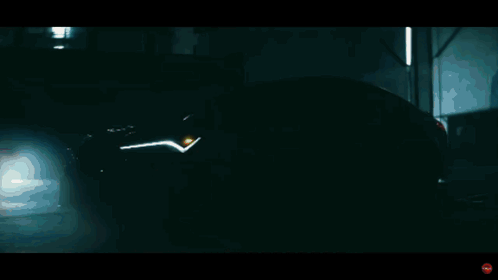A Close Up Of A Yellow Acura Car With A Red Headlight GIF