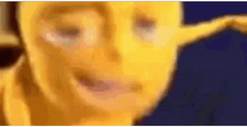 A Close Up Of A Yellow Cartoon Character 'S Face With A Blurry Background . GIF