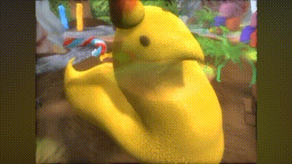 a close up of a yellow cartoon character with a green head