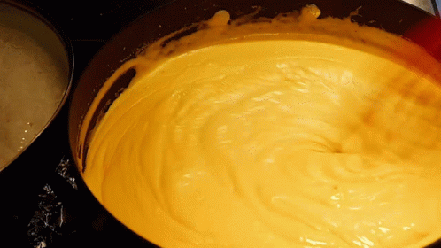 A Close Up Of A Yellow Sauce In A Pan GIF