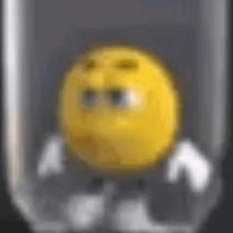 A Close Up Of A Yellow Smiley Face In A Glass GIF