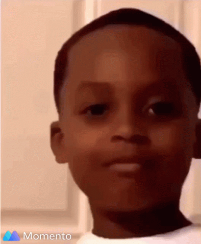 A Close Up Of A Young Boy 'S Face With The Words Momento On The Bottom GIF