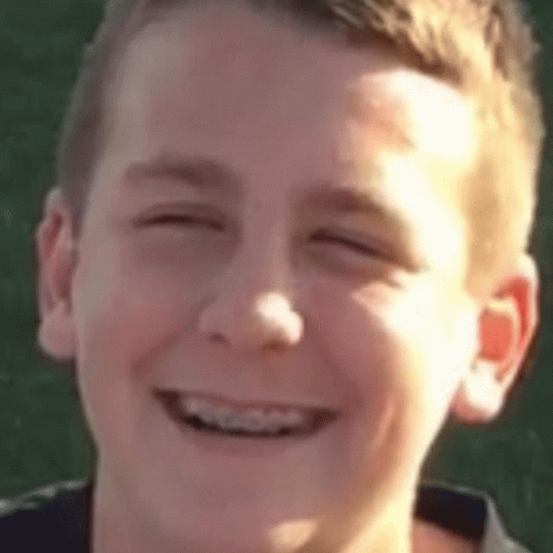 A Close Up Of A Young Boy Smiling With His Eyes Closed . GIF