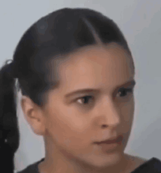 A Close Up Of A Young Girl 'S Face With A Ponytail . GIF