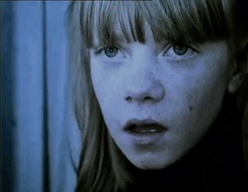 A Close Up Of A Young Girl 'S Face With Freckles . GIF