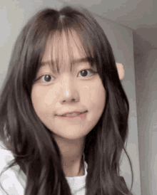 a close up of a young girl with long hair and bangs .