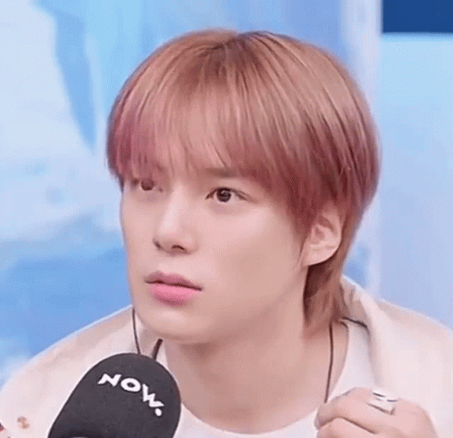 A Close Up Of A Young Man Holding A Microphone . GIF