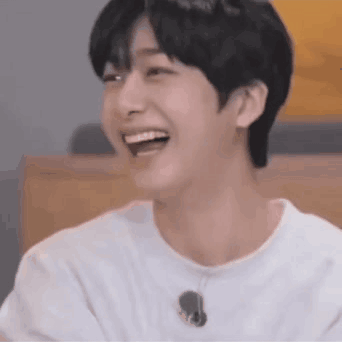 A Close Up Of A Young Man Laughing With His Mouth Open . GIF