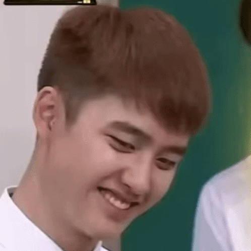 A Close Up Of A Young Man Making A Funny Face While Wearing A White Shirt . GIF