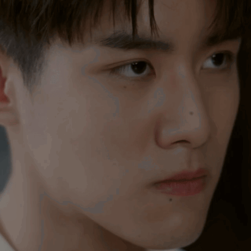 A Close Up Of A Young Man 'S Ear And Face GIF
