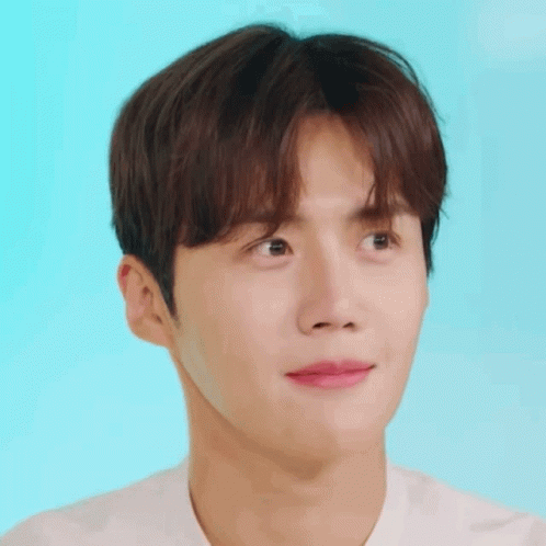 A Close Up Of A Young Man 'S Face Against A Blue Background GIF