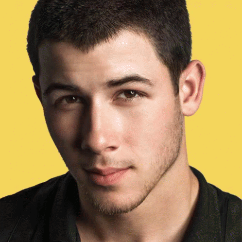 A Close Up Of A Young Man 'S Face Against A Yellow Background GIF