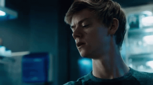 A Close Up Of A Young Man 'S Face In A Dark Room . GIF