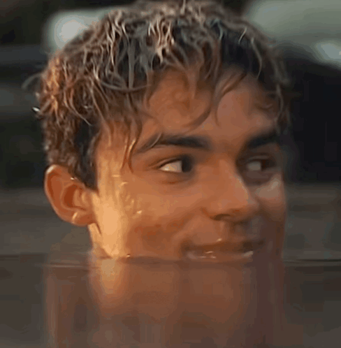 A Close Up Of A Young Man 'S Face In A Pool Of Water GIF