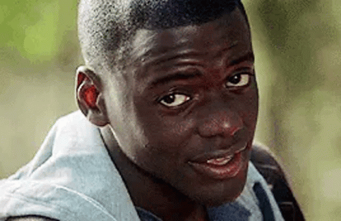 A Close Up Of A Young Man 'S Face Looking At The Camera . GIF