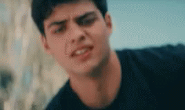 A Close Up Of A Young Man 'S Face Making A Funny Face . GIF