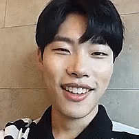 A Close Up Of A Young Man 'S Face Smiling . GIF