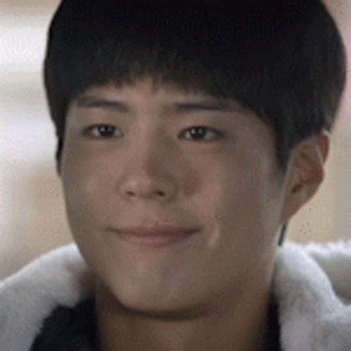 A Close Up Of A Young Man 'S Face Wearing A Fur Jacket GIF