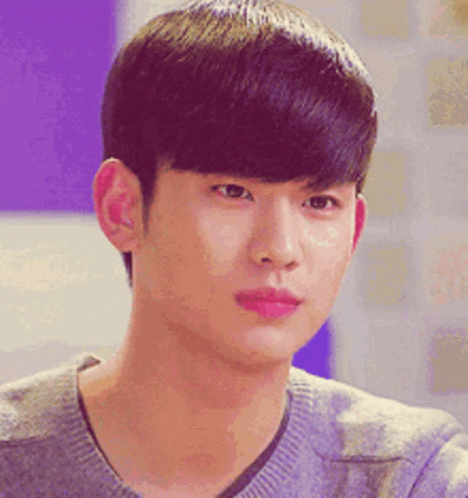 A Close Up Of A Young Man 'S Face Wearing A Gray Sweater GIF