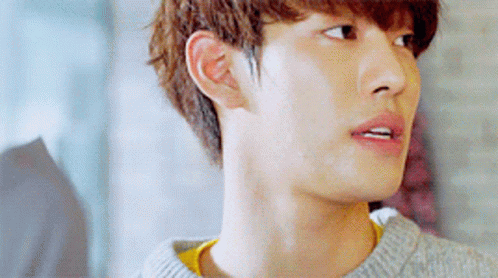 A Close Up Of A Young Man 'S Face Wearing A Grey Sweater GIF