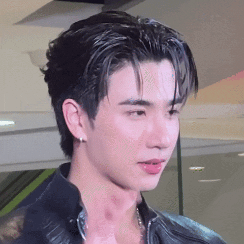 A Close Up Of A Young Man 'S Face With A Black Jacket On . GIF