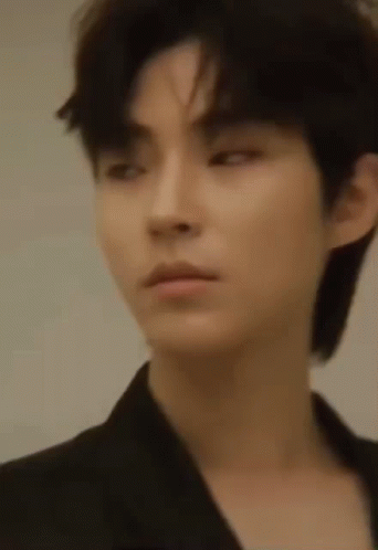 A Close Up Of A Young Man 'S Face With A Black Jacket On . GIF