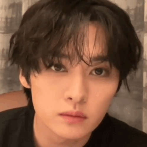 A Close Up Of A Young Man 'S Face With A Black Shirt On . GIF