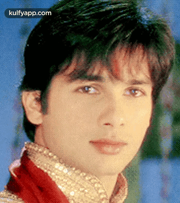 A Close Up Of A Young Man 'S Face With A Blue Background GIF