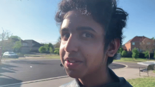 A Close Up Of A Young Man 'S Face With A Blue Sky In The Background GIF