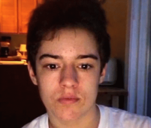 A Close Up Of A Young Man 'S Face With A Blurred Background GIF