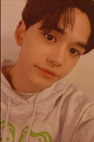 A Close Up Of A Young Man 'S Face With A Candle In The Background GIF