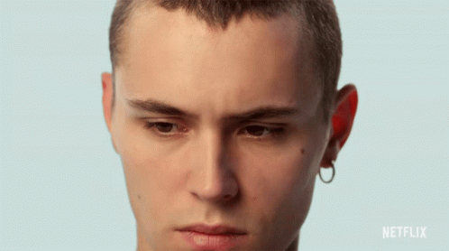 A Close Up Of A Young Man 'S Face With A Netflix Logo In The Corner GIF