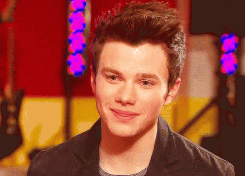 A Close Up Of A Young Man 'S Face With A Purple Light Behind Him GIF