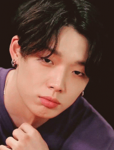 A Close Up Of A Young Man 'S Face With A Purple Shirt On GIF