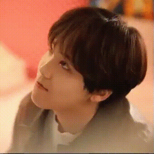 A Close Up Of A Young Man 'S Face With A Red Background . GIF