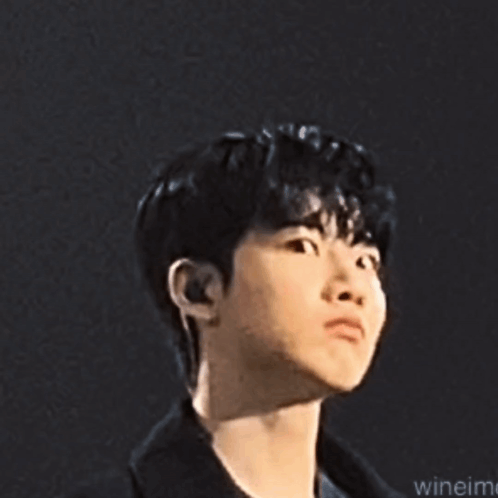A Close Up Of A Young Man 'S Face With A Serious Expression . GIF